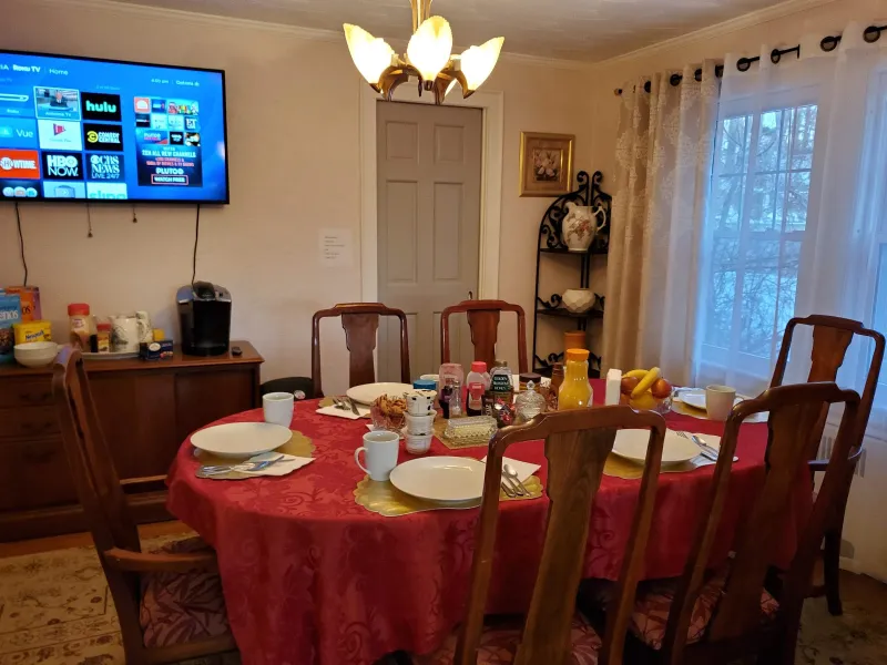 Breakfast room with a set table and red tablecloth