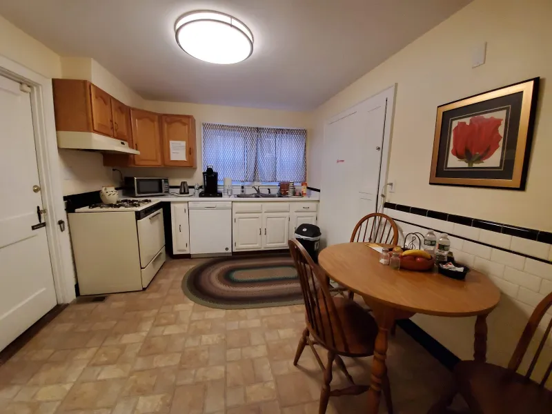 Guest kitchen with a table and chairs