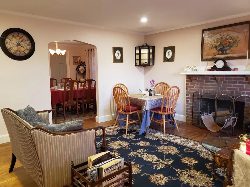 Dining table beside the brick fireplace