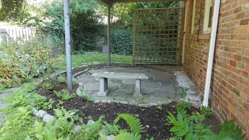 Garden patio with a stone bench